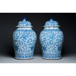 A pair of large Chinese blue and white 'lotus scroll' vases and covers, 19th C.