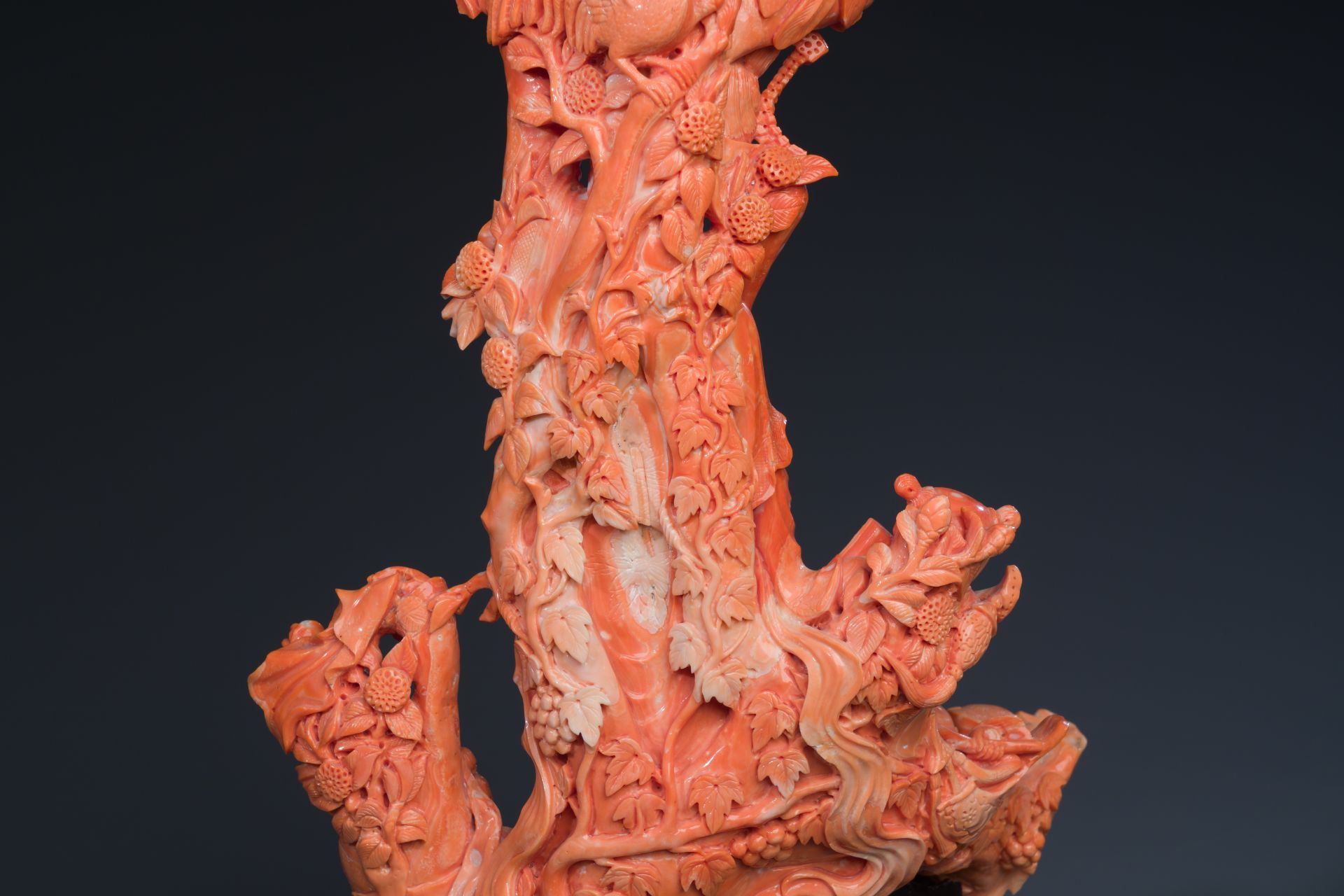 A large Chinese red coral group of a lady holding a cornucopia surrounded by children, 19/20th C. - Image 6 of 8