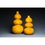 Two Chinese monochrome yellow-glazed triple gourd vases with incised designs of lotus scrolls and dr
