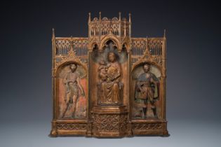 A large Spanish gilt and polychromed wooden triptych retable with Saint John the Baptist, the Virgin