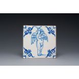 A rare blue and white Dutch Delft tile with a large cherub holding a sword, 1st half 17th C.