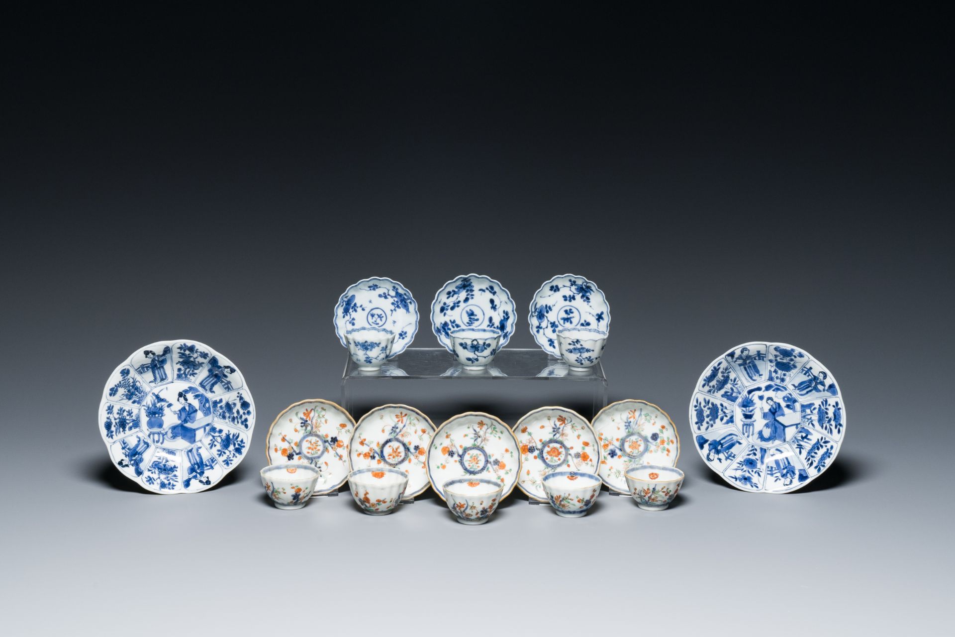Two Chinese blue and white plates, three cups and saucers and five famille verte cups and saucers, K