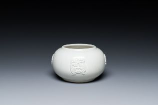 A Chinese white-glazed relief-molded bowl, Qianlong mark, 19th C.