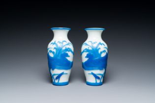 A pair of Chinese overlay Beijing glass vases with mandarin ducks in blue on white, 19/20th C.