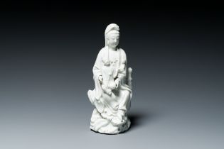 A Chinese Dehua blanc de Chine figure of Guanyin with a boy, Kangxi/Qianlong