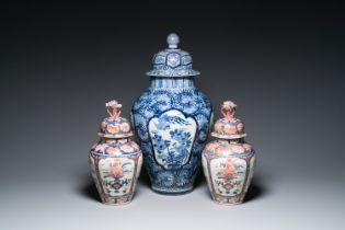 A pair of Japanese Imari vases with flower-topped covers and a large blue and white Arita vase, Edo,