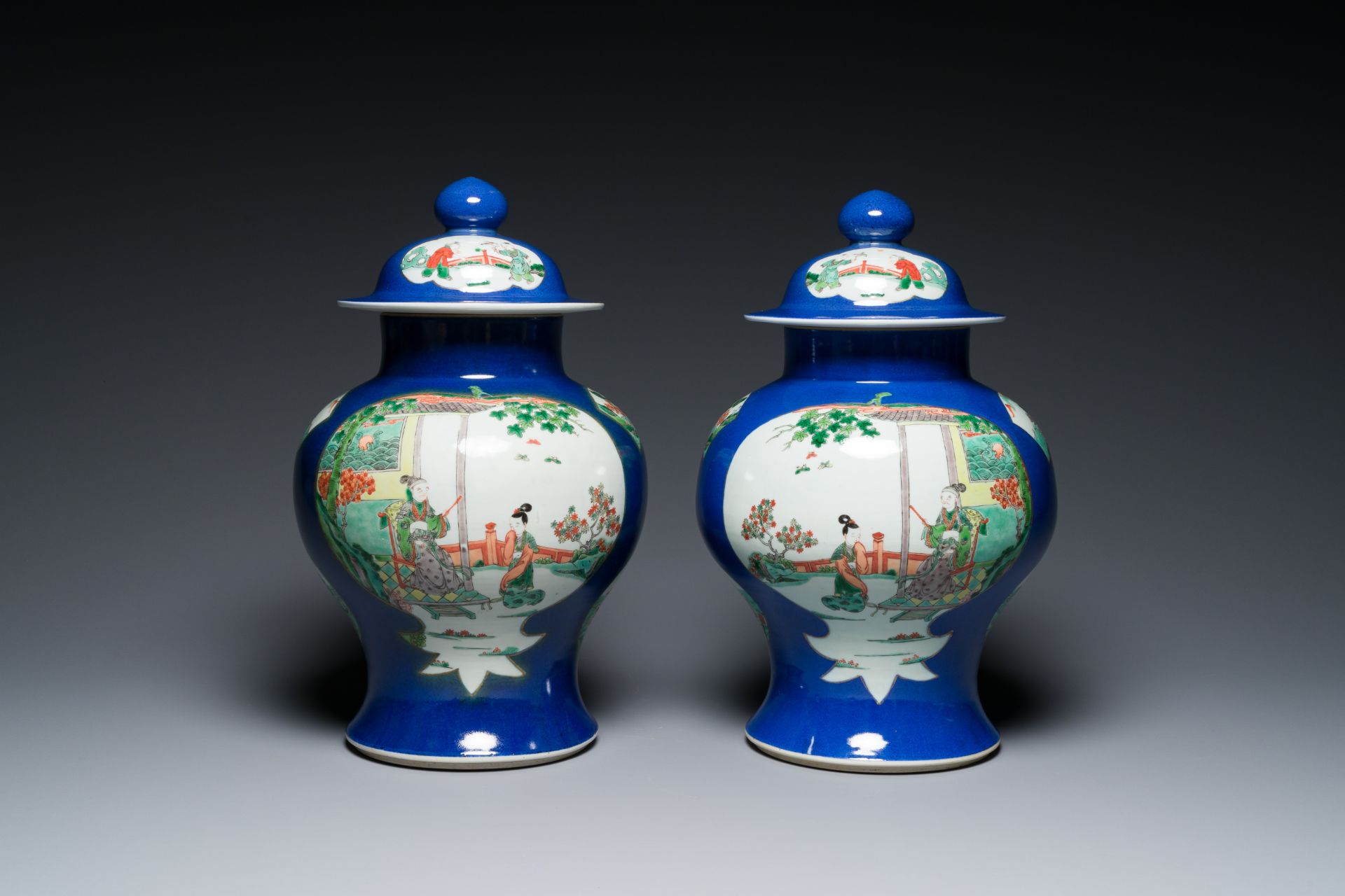 A pair of Chinese powder-blue-ground famille verte vases and covers, 19th C.