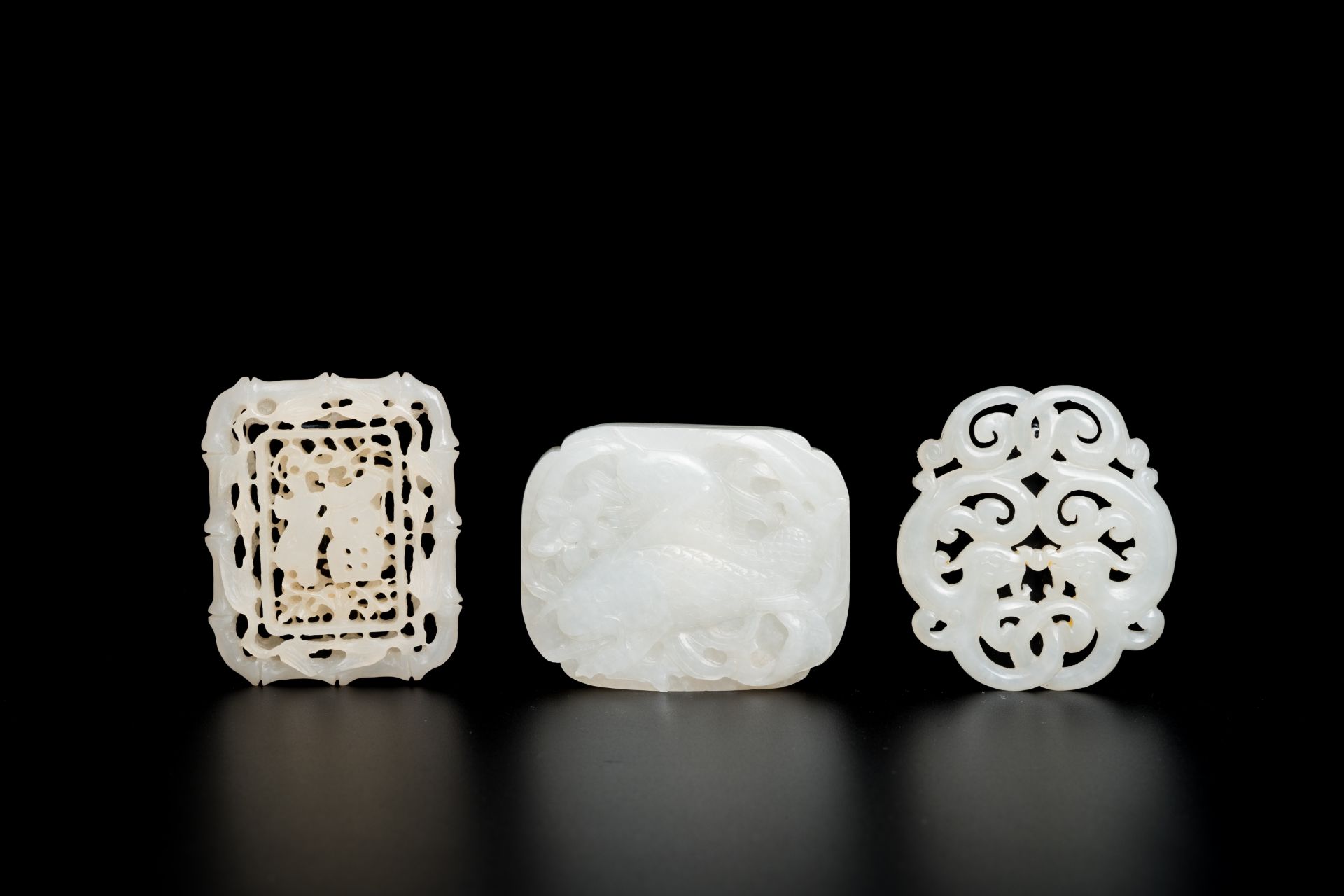 Two Chinese white jade reticulated carvings and a ruyi scepter plaque, Qing