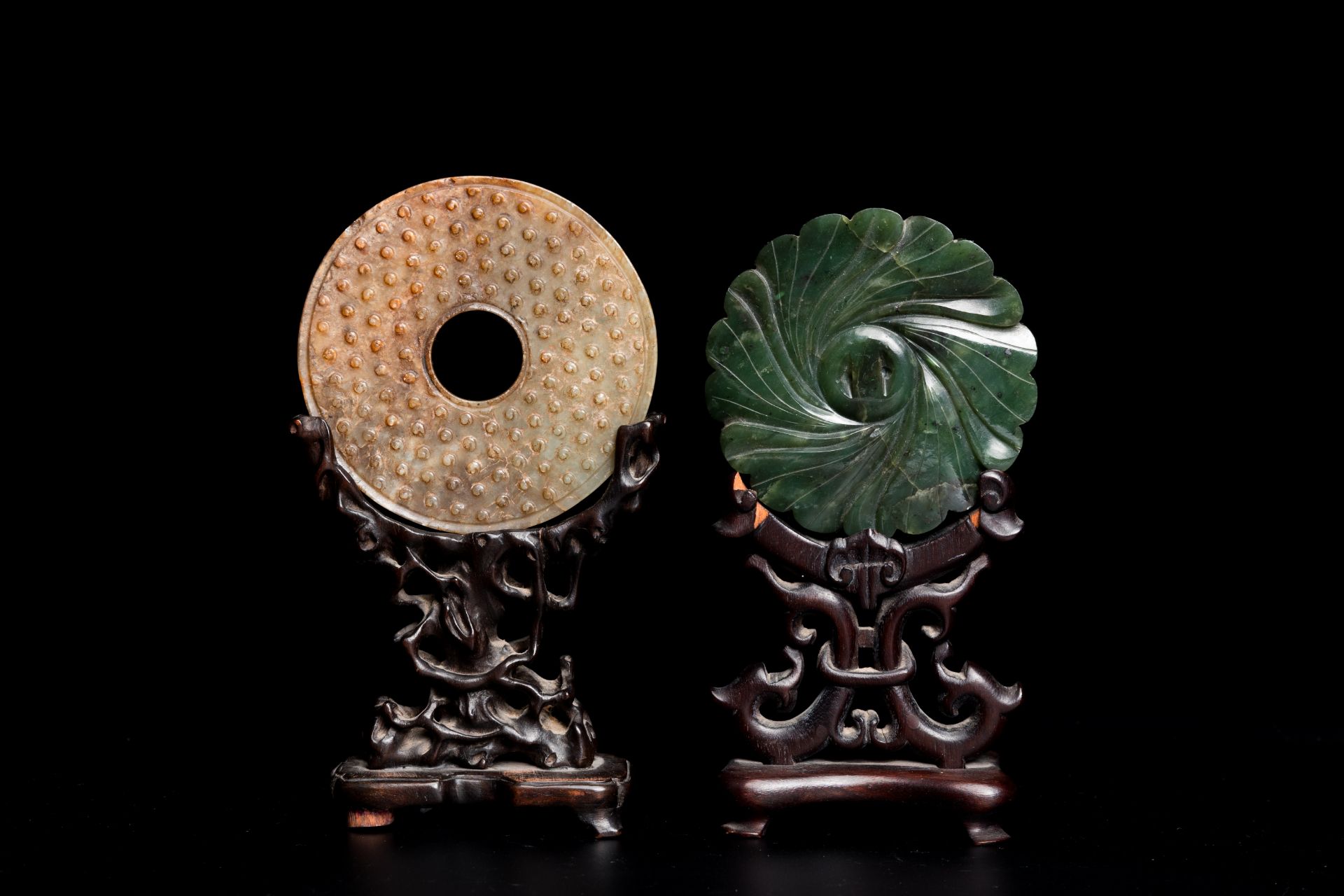 A Chinese celadon and russet jade 'bi' disc and a spinach green flower-shaped pendant on wooden stan - Image 3 of 9
