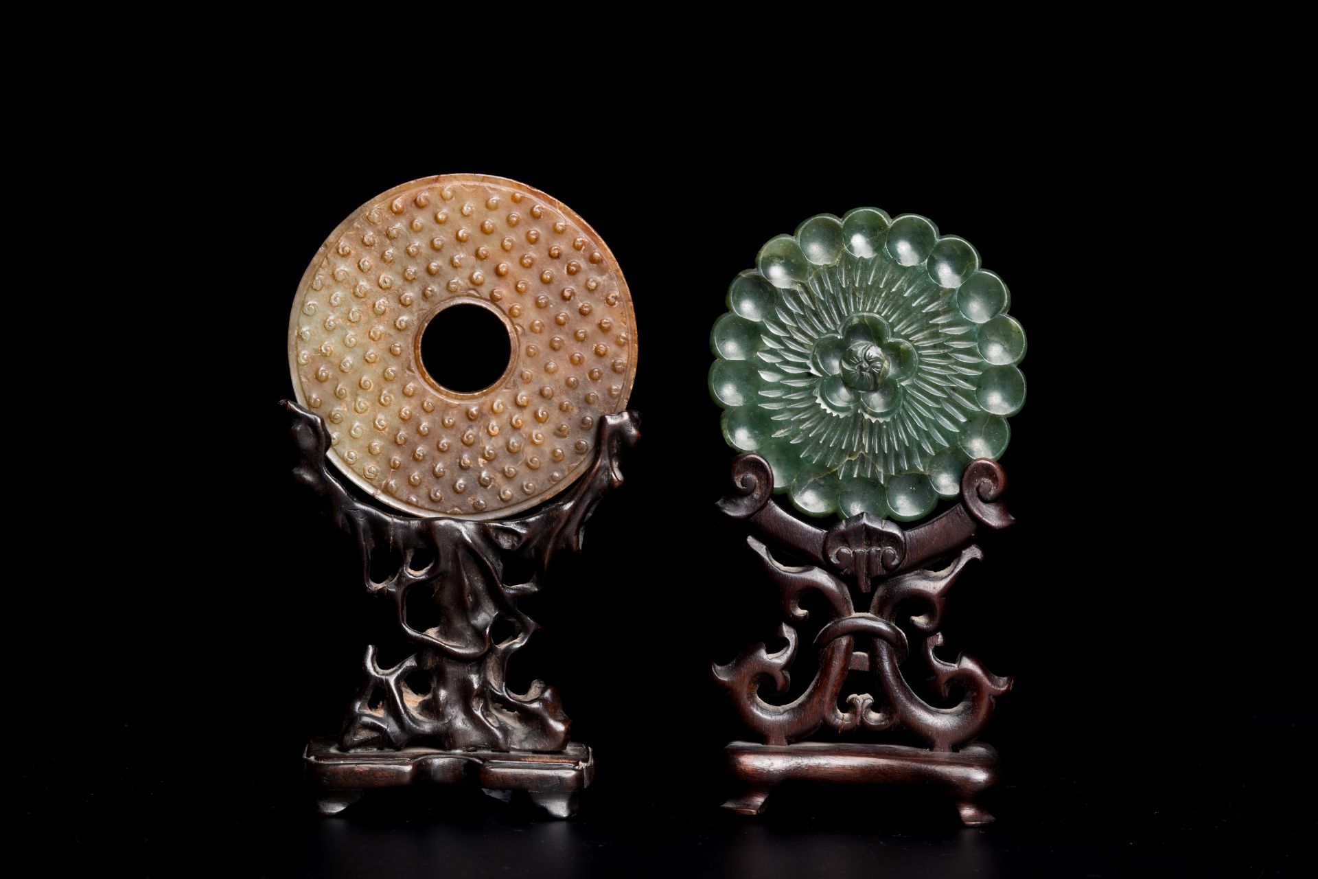 A Chinese celadon and russet jade 'bi' disc and a spinach green flower-shaped pendant on wooden stan - Image 2 of 9
