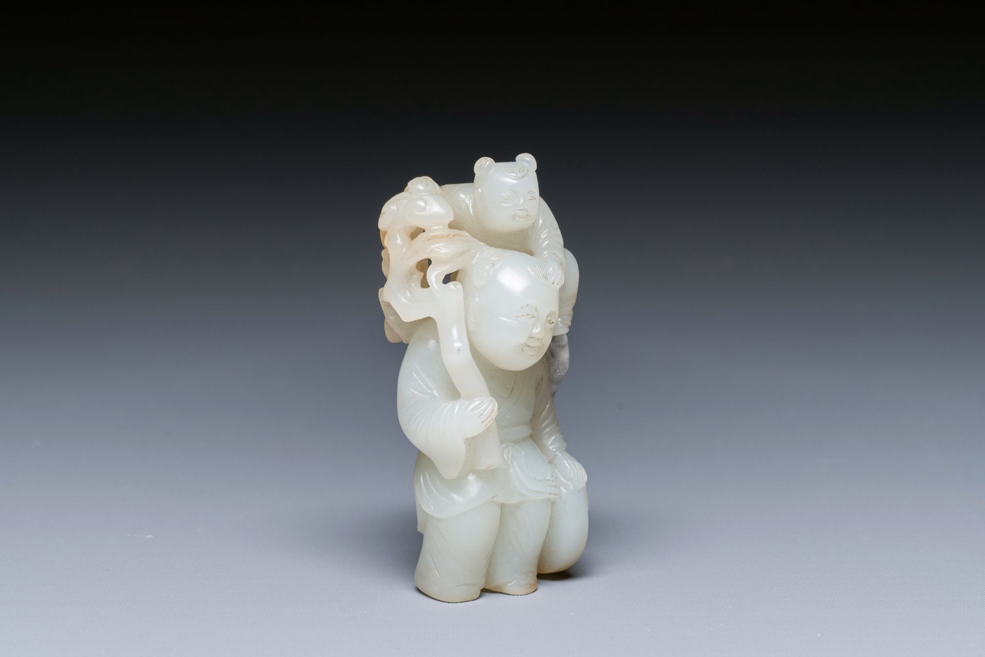 A Chinese white and russet jade sculpture of two boys, Qing