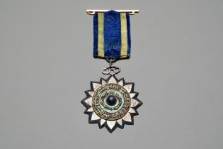 An imperial Chinese stone-inlaid enamelled metal 'Order of the Double Dragon' award medal, awarded o