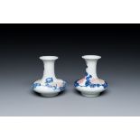 A pair of Chinese blue, white and copper-red vases with floral design, Qianlong mark, 19/20th C.