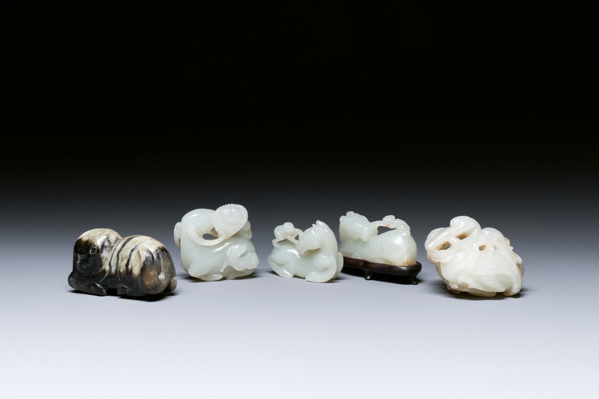 Five Chinese white, celadon and grey-black jade carvings, Qing/Republic