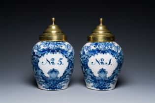 A pair of Dutch Delft blue and white tobacco jars with brass covers, 18th C.