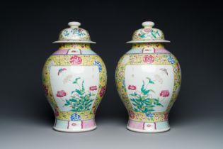 A pair of Chinese yellow-ground famille rose vases and covers, 19th C.