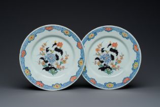 A pair of polychrome Dutch Delft plates with floral chinoiserie design with black accents, 18th C.