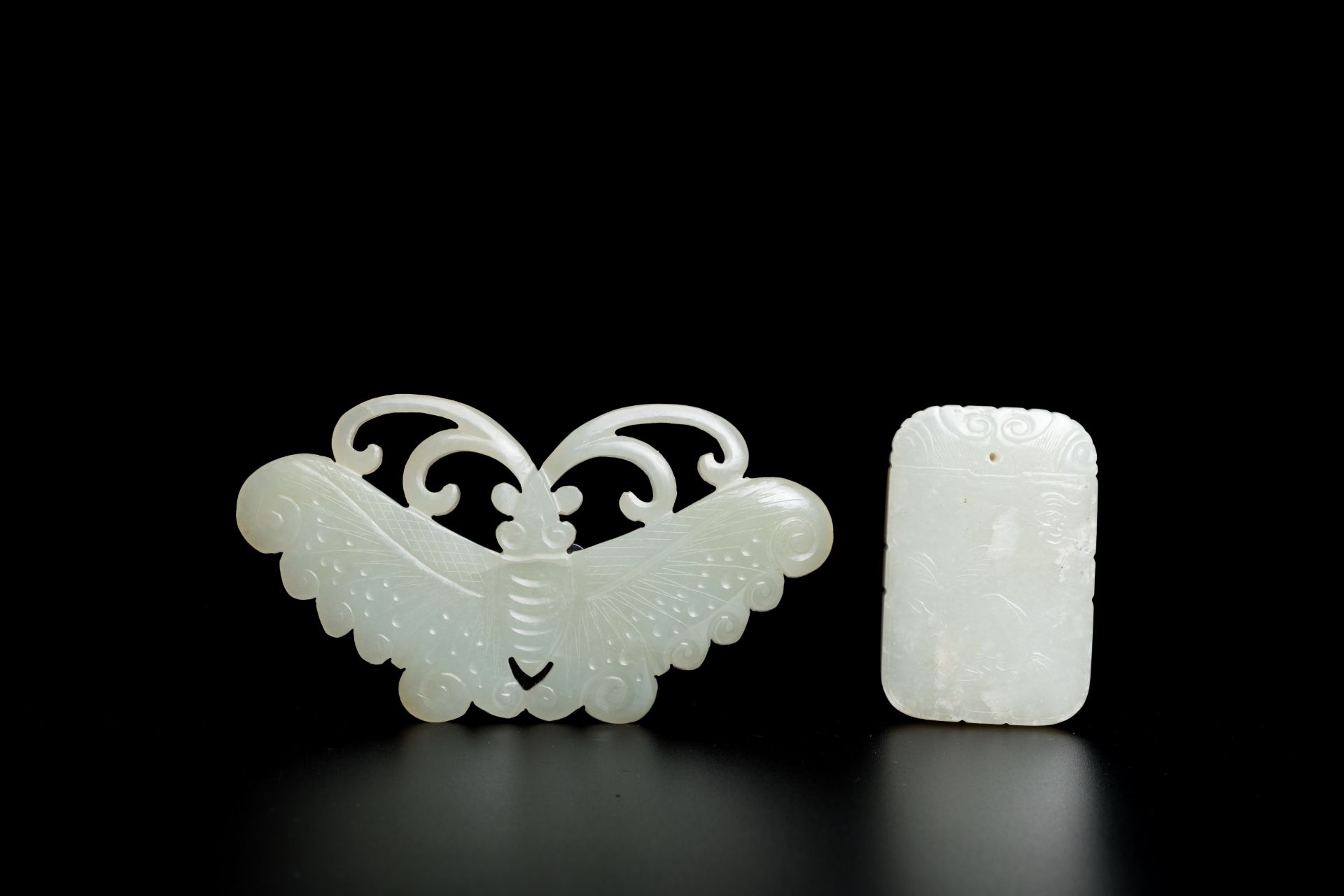 A Chinese white and russet jade pendant and a celadon jade 'butterfly' carving, Qing/Republic - Image 2 of 2