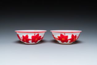 A pair of Chinese overlay Beijing glass bowls with floral design in red on white, 19th C.