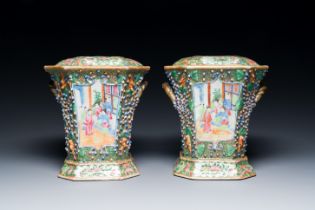 A pair of Chinese Canton famille rose flower holders and covers, 19th C.