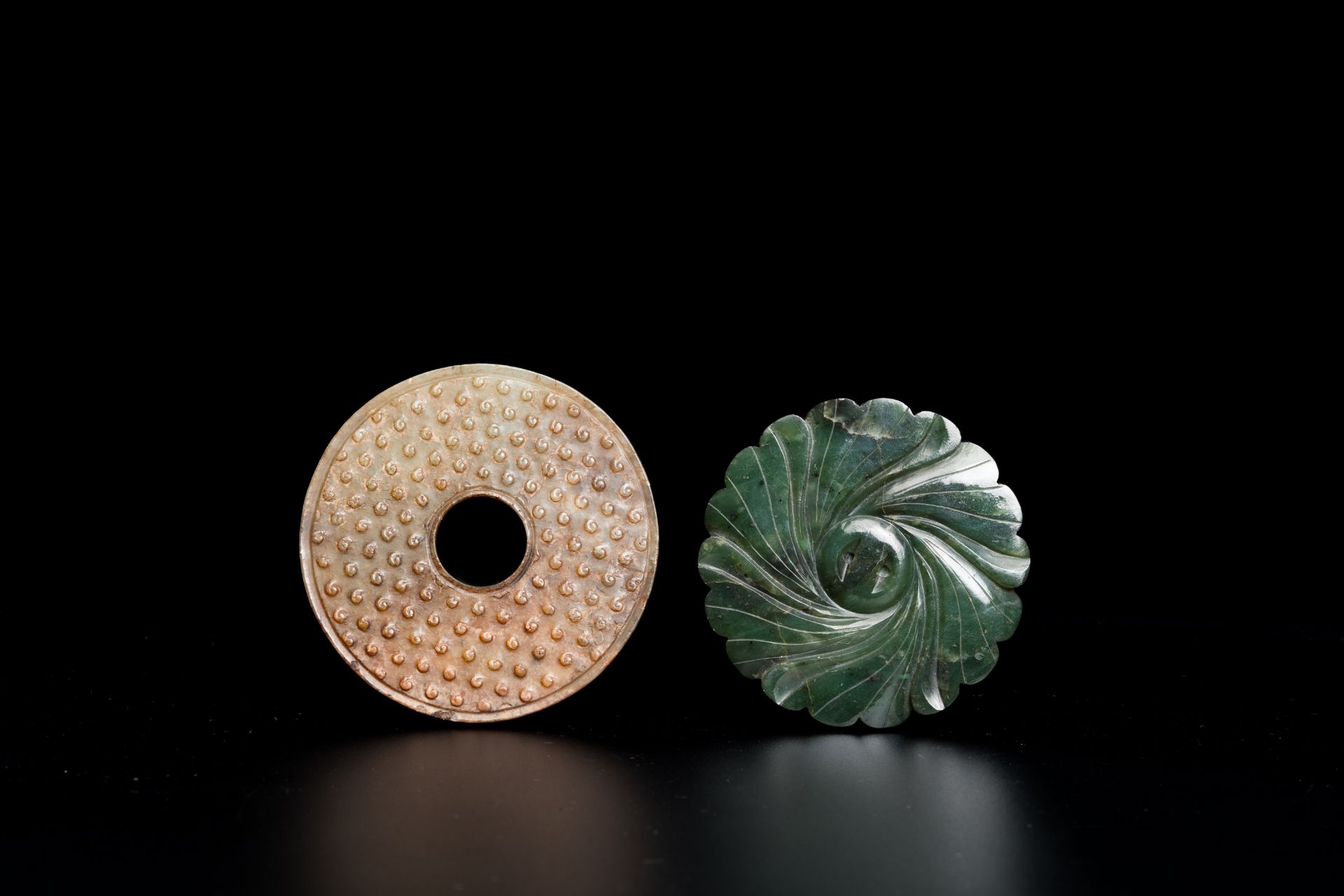 A Chinese celadon and russet jade 'bi' disc and a spinach green flower-shaped pendant on wooden stan - Image 7 of 9