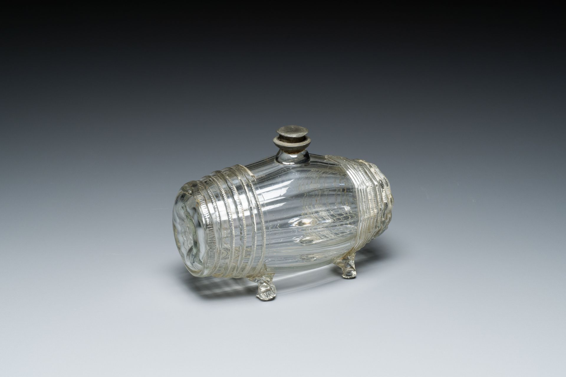 A German barrel-shaped glass bottle with pewter screw cap, 17/18th C.