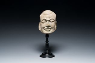 A Chinese sandstone head of Luohan, Yuan/Ming