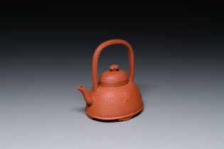 A Chinese Yixing stoneware carved 'chrysanthemum' teapot and cover, Kangxi