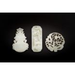 Three Chinese celadon and white jade pendants, Qing