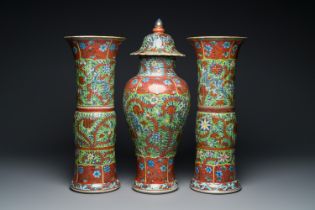 A Chinese English-decorated blue and white garniture of three vases, Kangxi