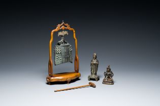 A Chinese bronze bell and two figures, Ming and later