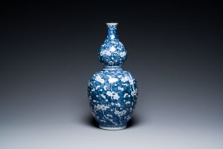 A Chinese blue and white double gourd 'prunus on cracked ice' vase, 18th C.