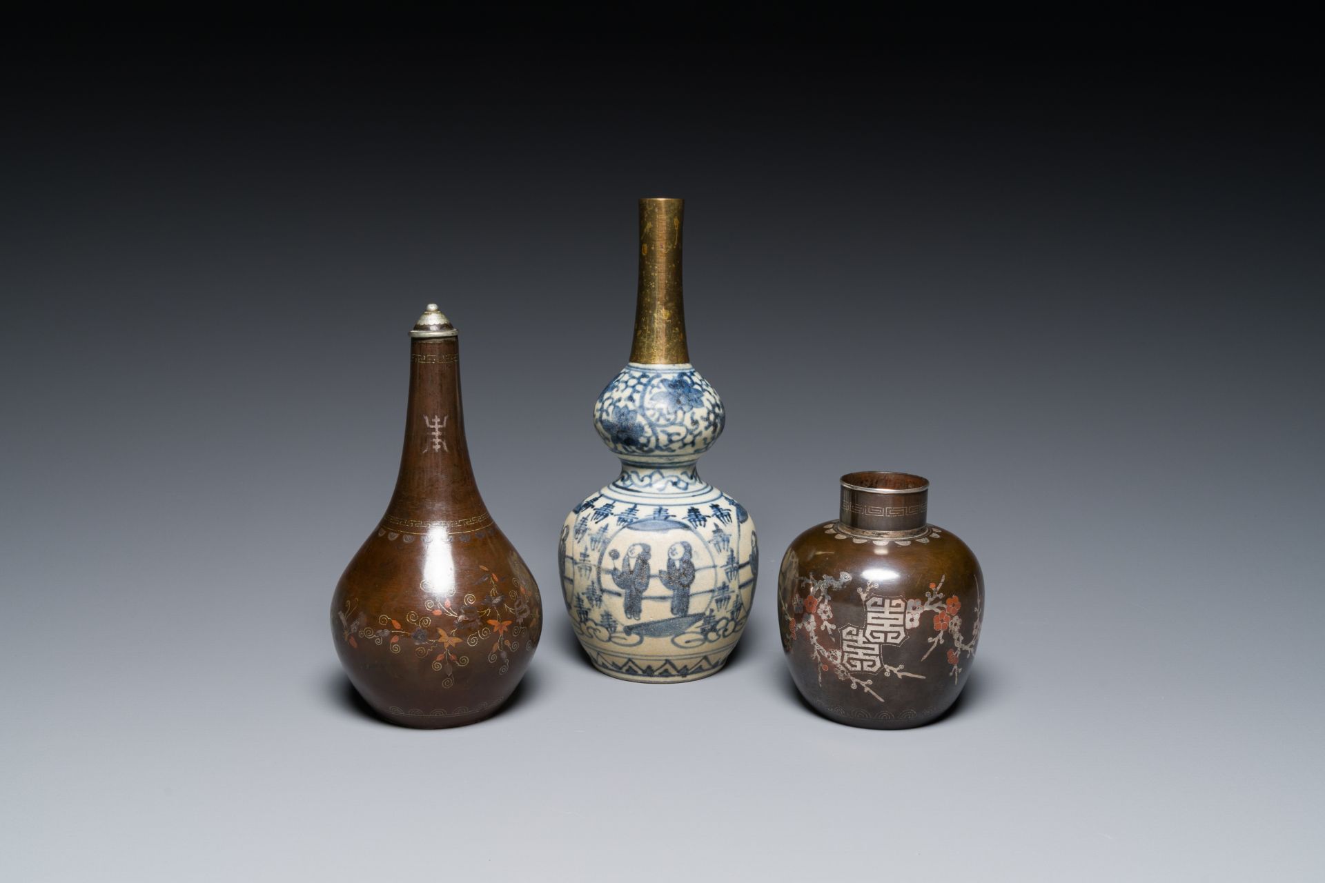 Two Vietnamese copper- and silver-inlaid paktong wares and a Chinese blue and white double gourd vas