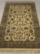 CONTEMPORARY RUG - green ground with multiple floral and foliage pattern borders, label for "B & Q",