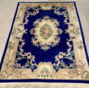 CHINESE WASHED WOOLEN RUG - cobalt blue and cream ground with floral border and central motif,