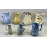 VICTORIAN POTTERY JUGS (7) - with floral moulded bodies, the tallest with hinged pewter cover, 25cms