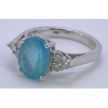 18CT WHITE GOLD PARAIBA TOURMALINE & DIAMOND RING - oval facet cut central stone, 8 x 11mm, claw set