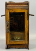 EDWARDIAN OAK SMOKER'S CABINET - folding pipe holders to side, glazed door enclosing interior fitted