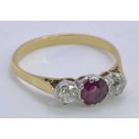 18CT GOLD THREE STONE RUBY & DIAMOND RING - 0.33ct central ruby flanked by two 0.10ct diamonds,