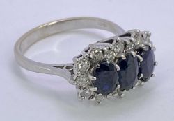 18CT WHITE GOLD DIAMOND & SAPPHIRE CLUSTER RING - having three faceted oval blue central stones, 6 x