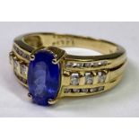 18CT GOLD TANZANITE & DIAMOND RING - 1.99ct claw set oval central stone, 10 x 6mm, with three inline