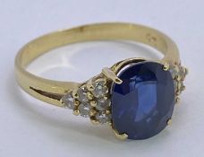 18CT GOLD BLUE SAPPHIRE & DIAMOND RING - 1.5ct approx, facet cut oval sapphire, 9 x 7mm, claw set to