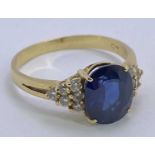 18CT GOLD BLUE SAPPHIRE & DIAMOND RING - 1.5ct approx, facet cut oval sapphire, 9 x 7mm, claw set to