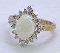 9CT GOLD STAR CLUSTER OPAL & DIAMOND DRESS RING - 10 x 8mm claw set oval opal, surrounded by 20