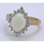 9CT GOLD STAR CLUSTER OPAL & DIAMOND DRESS RING - 10 x 8mm claw set oval opal, surrounded by 20