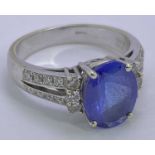 18CT WHITE OVER YELLOW GOLD BLUE TANZANITE & DIAMOND RING - 2.78ct central stone, 11 x 8mm, facet