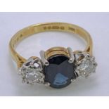 18CT GOLD & PLATINUM 3 STONE DARK BLUE SAPPHIRE & DIAMOND RING - 9 x 7mm the central stone,