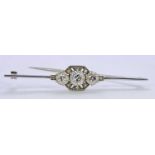 UNMARKED WHITE GOLD OR PLATINUM DIAMOND SET BAR BROOCH - having a central 0.50ct round cut diamond