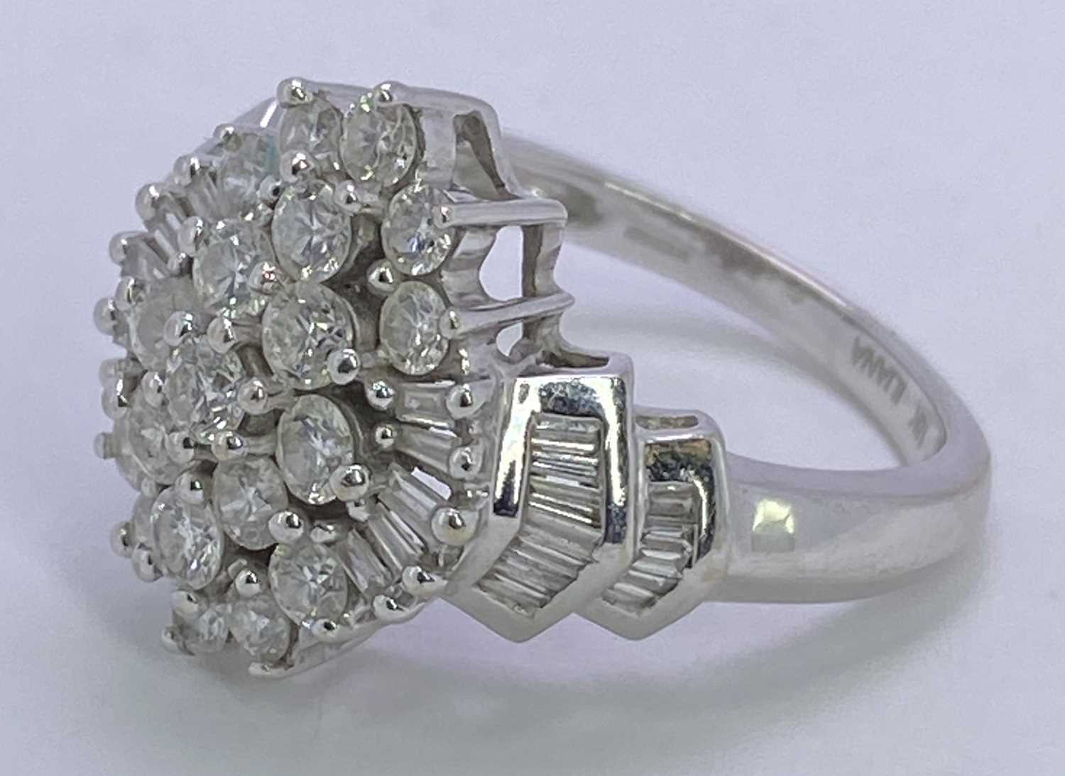18CT WHITE GOLD DIAMOND CLUSTER RING - having a tiered arrangement of 19 round brilliants and