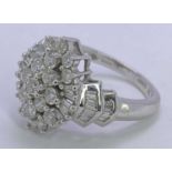 18CT WHITE GOLD DIAMOND CLUSTER RING - having a tiered arrangement of 19 round brilliants and